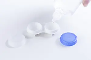 Ophthalmology Concept Drucke: Liquid for lenses is poured into the boxes