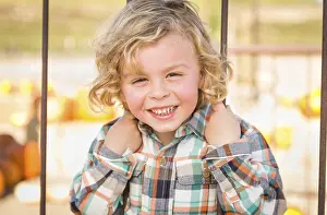 Rustic Ranch Setting Drucke: Little boy having fun in a rustic ranch setting at the pumpkin patch