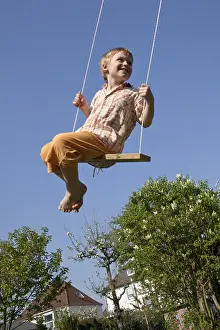 Full Body Length Photography Drucke: Little boy on a swing