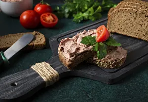 Dark Background Images Drucke: Liver meat pate spread on rye bread
