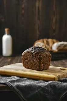Black Table Setup Drucke: Loaf of artisan rye bread on a table