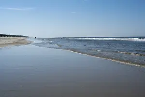 Sandy Coastline Europe Drucke: Long sandy beach with outgoing waves