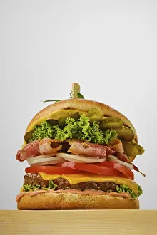 Cheese And Vegetable Dish Drucke: Low angle view of beef burger with bacon