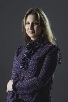 Confident Pose Drucke: Low key portrait of size plus model in blouse posing in studio