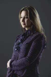 Brown Haired Woman Looking At Camera Drucke: Low key portrait of size plus model in blouse posing in studio