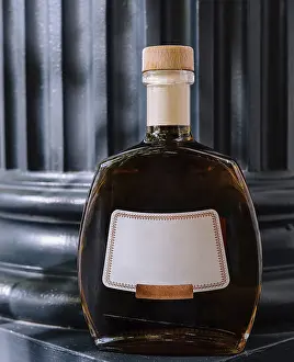 Indulgent Food And Drink Drucke: Luxurious cognac bottle elegantly displayed on a dark surface