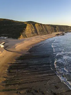 Deserted Beach At Low Tide Drucke: Magoito Beach and Cliffs at Sunset during Low Tide