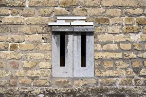 Deserted Postal Service Drucke: Mailboxes integrated into a brick wall