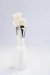 Cosmetic Brushes Drucke: Make up brushes of different size and type in a glass against white background