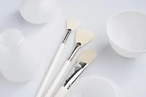 Professional Makeup Tools Drucke: Make up brushes of different size and type object high angle shot on white surface
