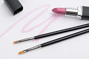 White Background Cosmetics Drucke: Make up brushes and pink lipstick isolated high angle object view against white background