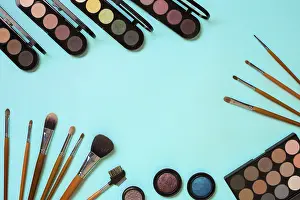 Blue Background Cosmetics Drucke: Make up essentials. Set of professional make up brushes