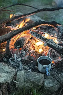 Forest Scenery At Sunset Drucke: Making coffee on campfire in the forest