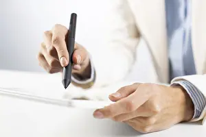 Business Attire And Computer Use Drucke: Man in business suit using tablet computer