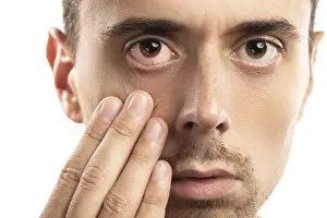 Bright White Background Photo Drucke: Man checking condition of his eye on white background