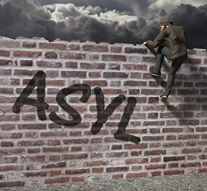 Refugee Crisis In Europe Drucke: Man climbing over a wall with writing asylum