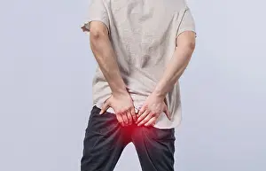 Diarrhea Problem Drucke: Man with diarrhea problem, man with digestive problem touching his buttock