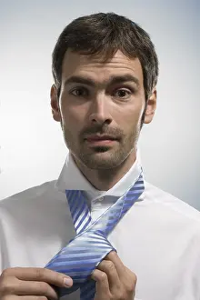 Caucasian Male Drucke: Man doing up his tie