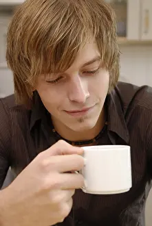 Food And Drink Images Drucke: Man drinks a cup coffee