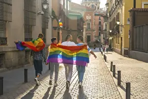 Symbolic Rainbow Picture Drucke: Man with his back facing the demonstration with the rainbow flags