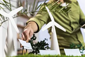 Eco Friendly Energy Source Drucke: Man fixing up eco friendly wind power project layout