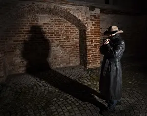 Self Confident Male Model Drucke: Man with hat and leather coat, shadow in the back