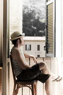 European Summer Atmosphere Drucke: Man with hat sitting next to window