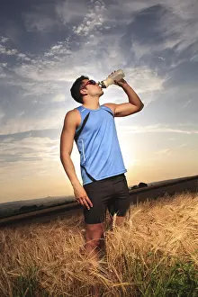 Sportsman In Action Drucke: Man jogging through the fields