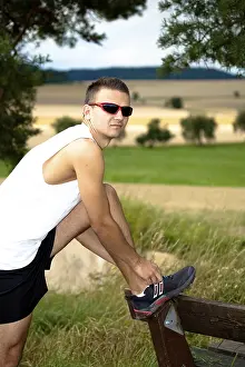 Outdoor Recreational Activity Drucke: Man jogging through the fields