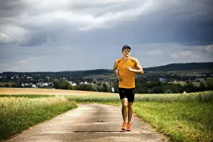 Athletic Male Drucke: Man jogging through the fields
