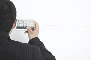 Studio Shot Of Man Drucke: Man listens to a can
