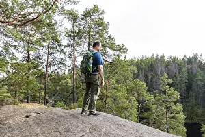Nature Conservation Area Sweden Drucke: Man looking at lake and forest