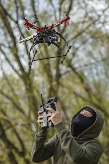Drone Aerial Photography Drucke: Man in mask operating a drone with remote control