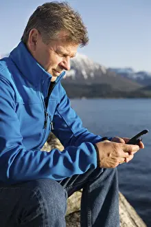 Waterfront Landscape Photography Drucke: Man with mobile phone