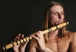 Studio Shot Of Musician Drucke: A man playing his wind instrument with expression