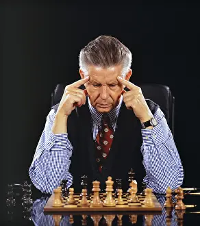 German Studio Shot Drucke: A man plays chess and thinks, 60