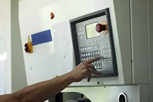 Passenger Traffic Control Drucke: Man presses button on electronic control panel