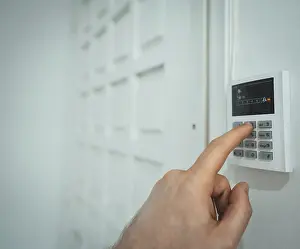 No People In Background Drucke: Man putting code in alarm system panel at home