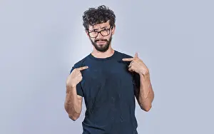 Confused Man Drucke: Man with puzzled face pointing at himself