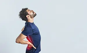 Young Adult Back Pain Drucke: Man with spine problems, person with back problems on isolated background