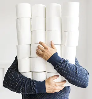 Corona Virus Pandemic Drucke: Man with stack toilet paper