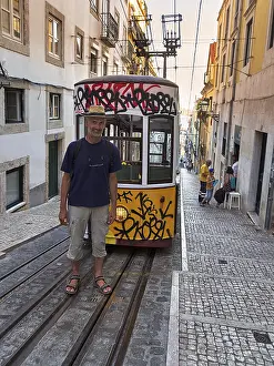 Portugal Tourism Drucke: Man standing on rails in front of funicular