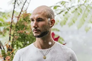 Serene Landscape Drucke: A man stands in the rain, deep in thought