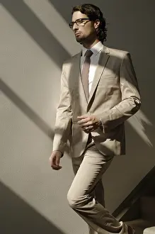 Fashionable Business Attire Drucke: Man in a suit, going down the stairs