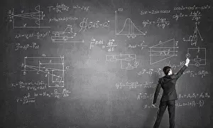 Man In Suit Drucke: Man in suit standing with back and drawing formulas on chalkboard