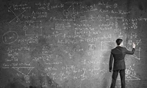School Classroom Scene Drucke: Man in suit standing with back and drawing physics formulas