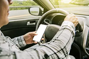 Man On Phone While Driving Drucke: Man using his phone while driving