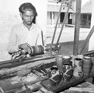Metal Working Machinery Drucke: Man using portable rotating lathe