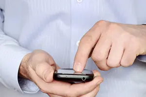 Businessman On Phone Drucke: Man using a smartphone
