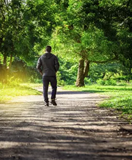 Latin American Ethnicity Portrait Drucke: Man walking down a desolate road